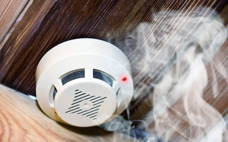 Illustration of a smoke alarm sounding off in a smoky room
